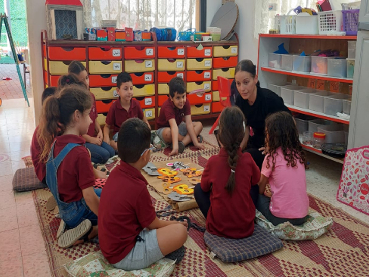 קבוצת ילדים עם מנחה בגן